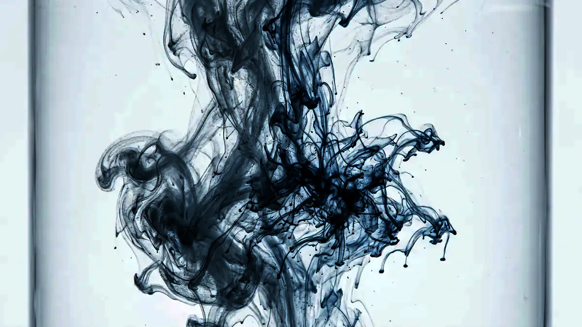 A pale plume blooming through clear water, branching into fine threads.