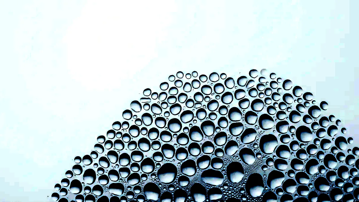 Extreme close-up of condensation beads on a cold glass surface.