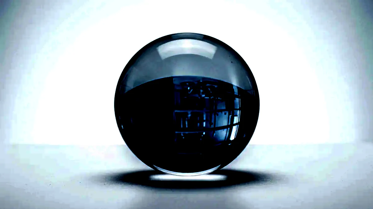 A clear glass sphere on a white surface, inverting the space behind it.
