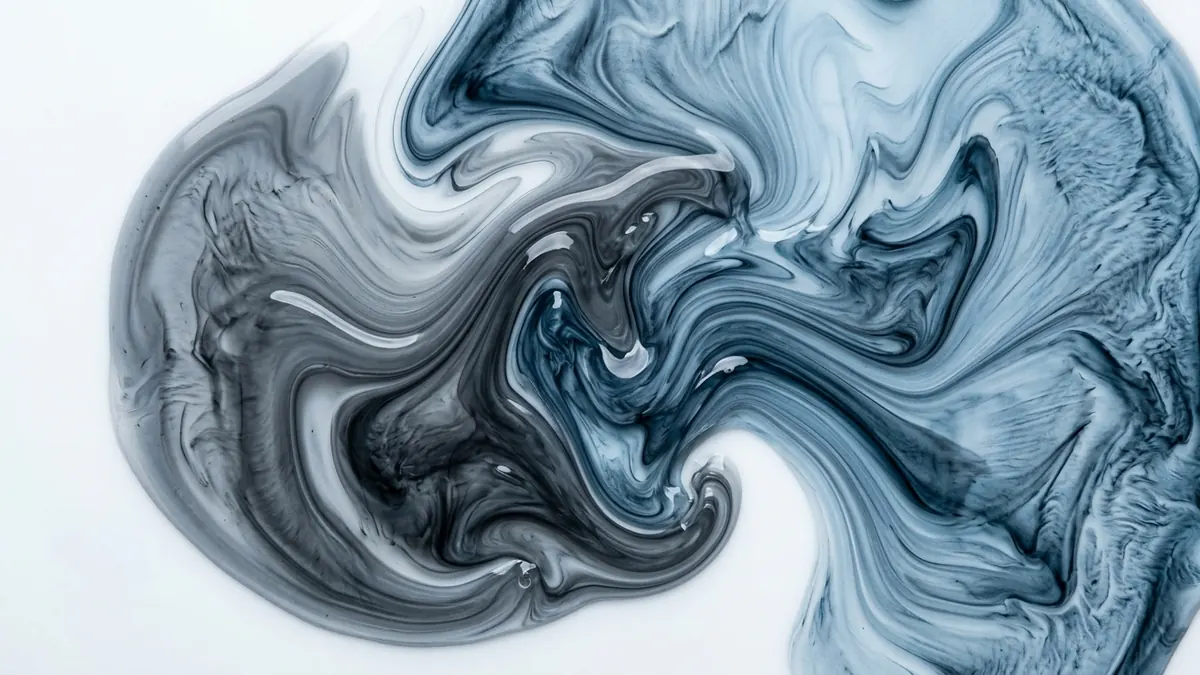 Overhead macro of two clear viscous fluids marbling into one another.